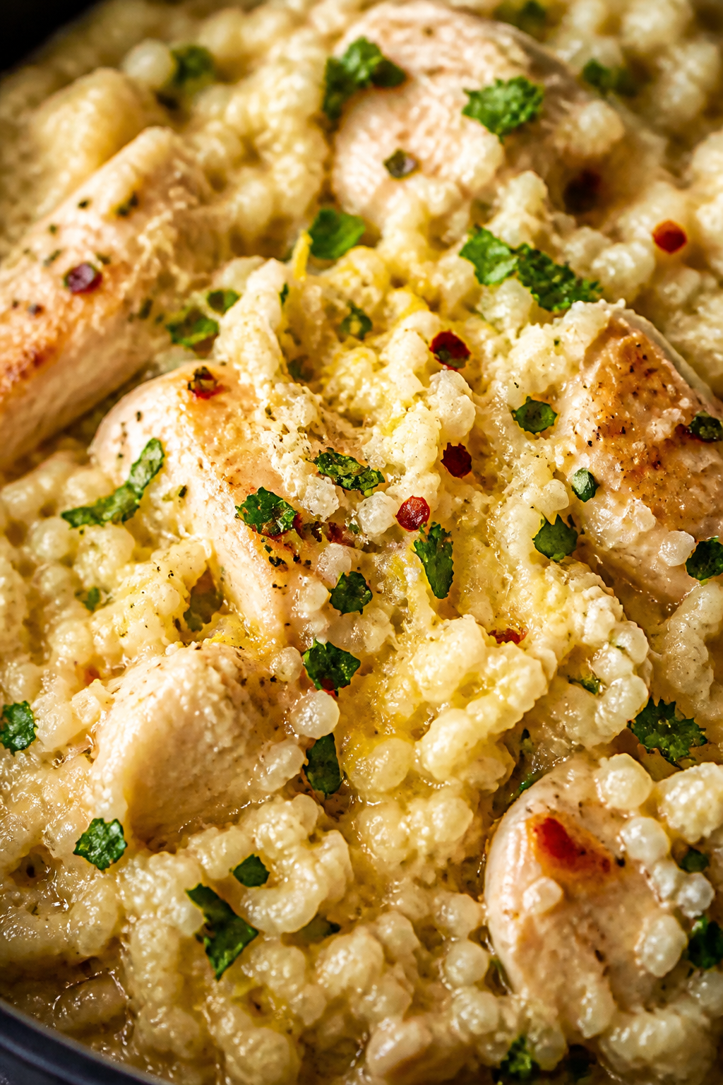Close-up creamy cauliflower rice finish: Tight macro shot of garlicky cauliflower rice just after st