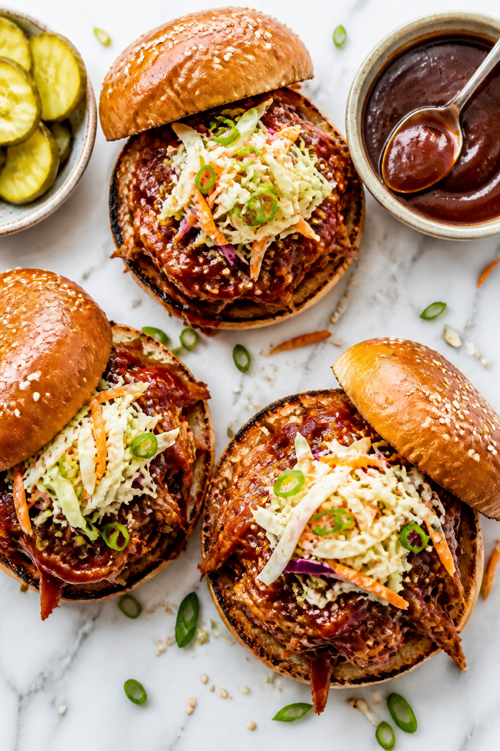Tasty top-down sandwich scene: Overhead shot of pulled BBQ chicken piled onto toasted brioche buns, 