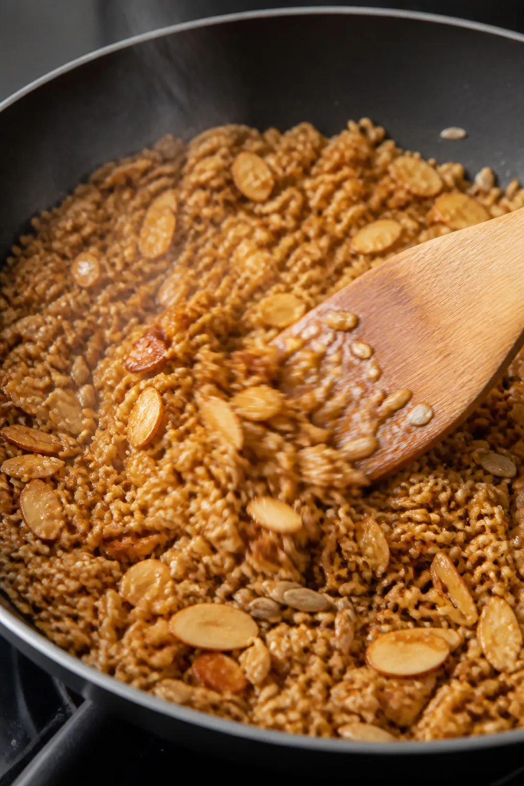 Cooking process close-up: Golden toasted ramen crunch mix sizzling in a wide skillet—crushed ramen