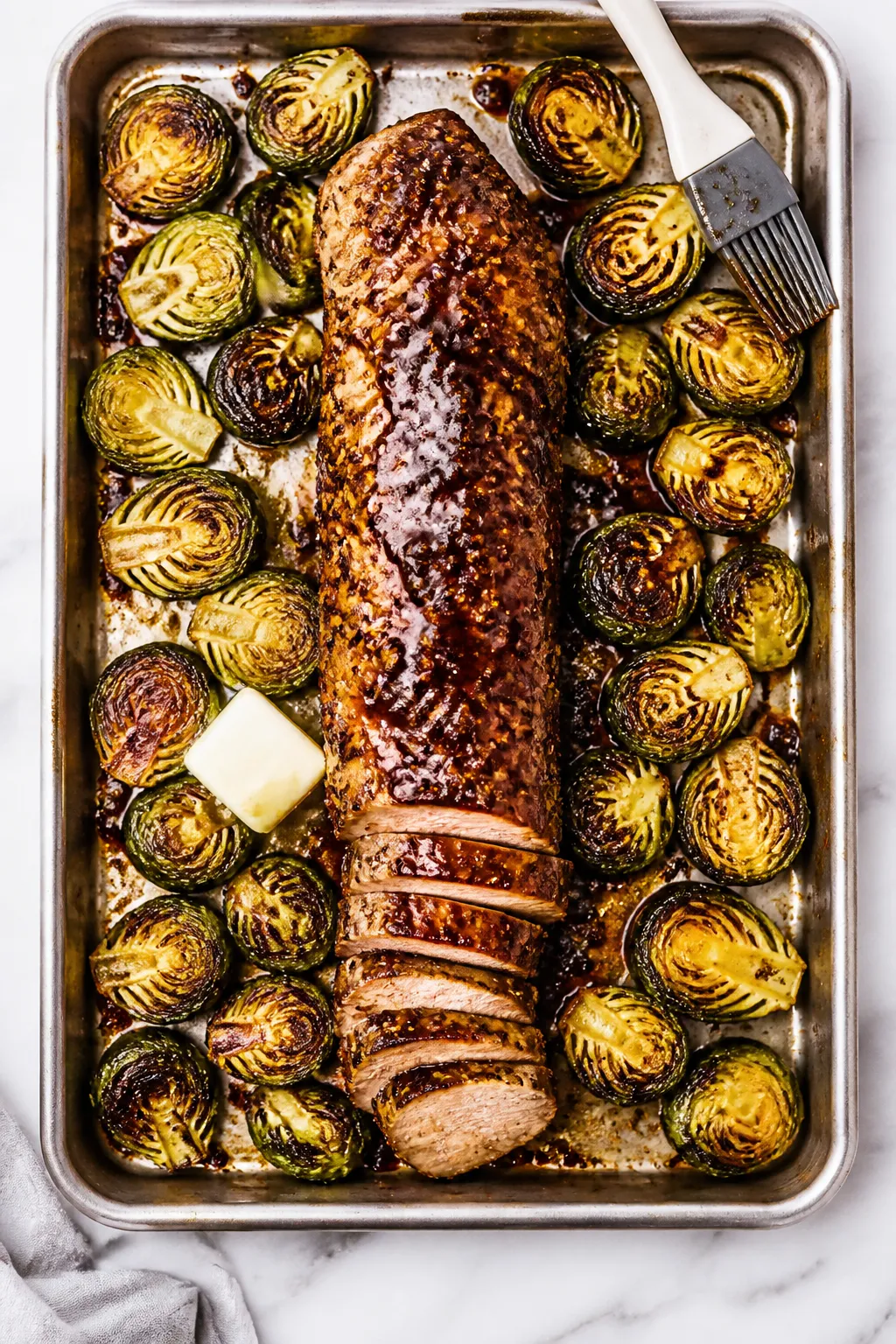 Cooking process: Overhead shot of a hot sheet pan just out of the 425°F oven—seared pork tenderlo