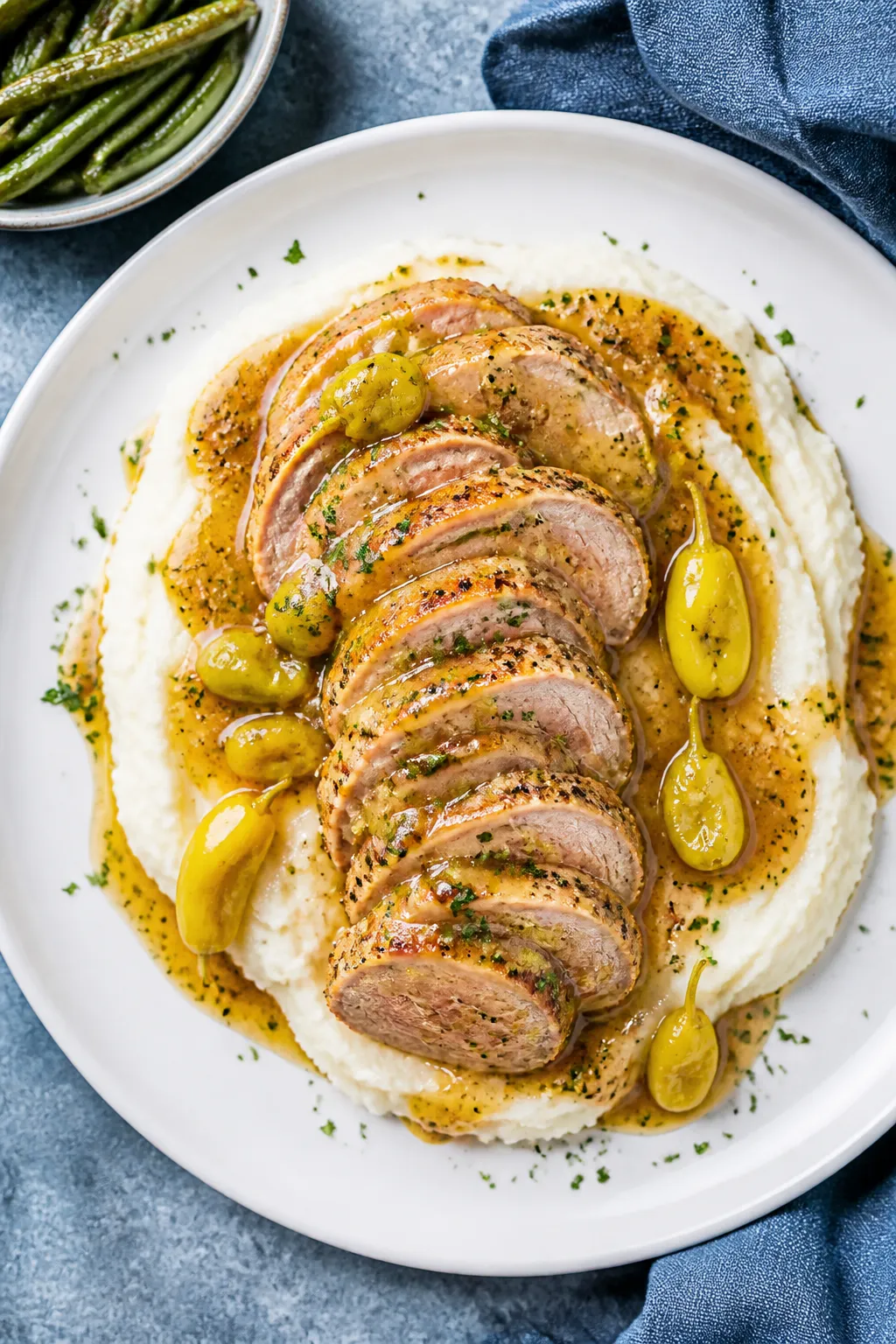 Final plated presentation: Restaurant-quality plate of Mississippi pork tenderloin fanned into 1/2-i