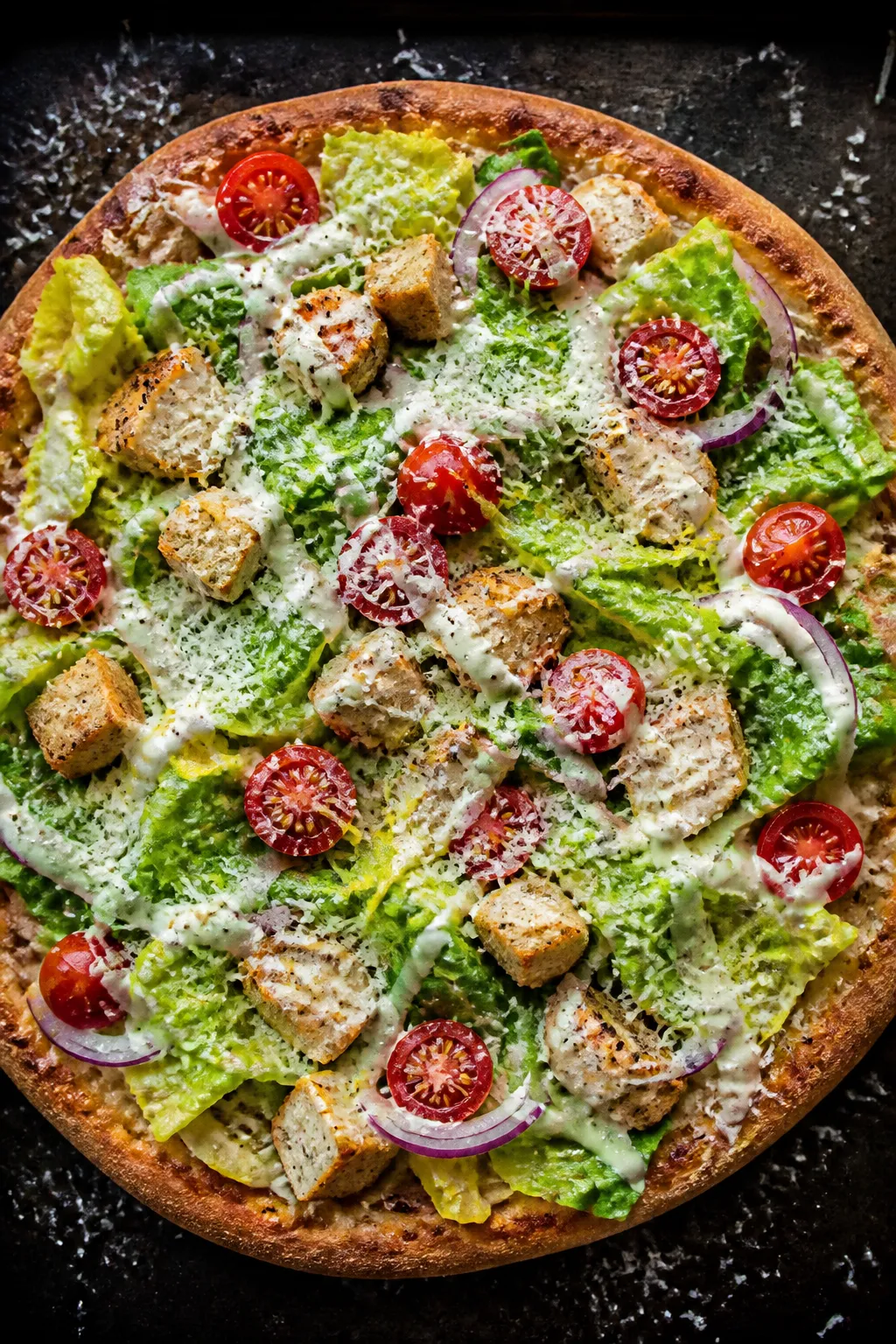 Overhead final assembly: Healthy Chicken Caesar Salad Pizza just out of the oven, topped with glossy