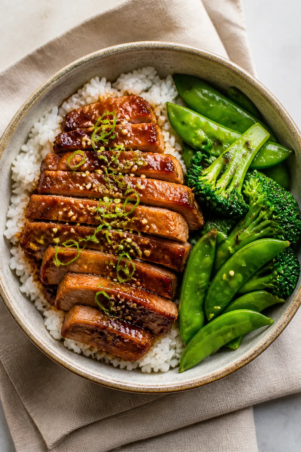 Tasty top view final plate: Overhead shot of a composed bowl—steamed white rice topped with glossy