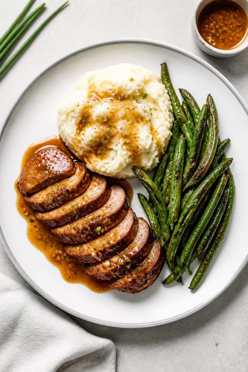 Tasty top view final plate: Overhead shot of beautifully plated honey garlic glazed pork tenderloin