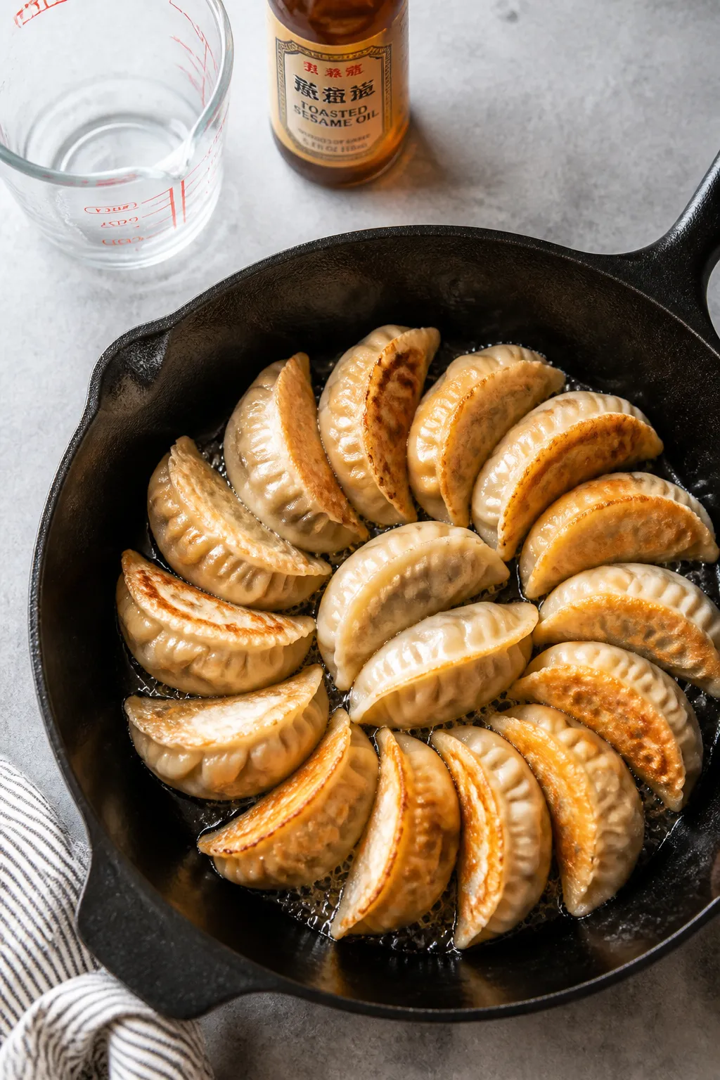 Tasty top view: Overhead shot of a skillet batch mid-process—potstickers in a neat circular patter