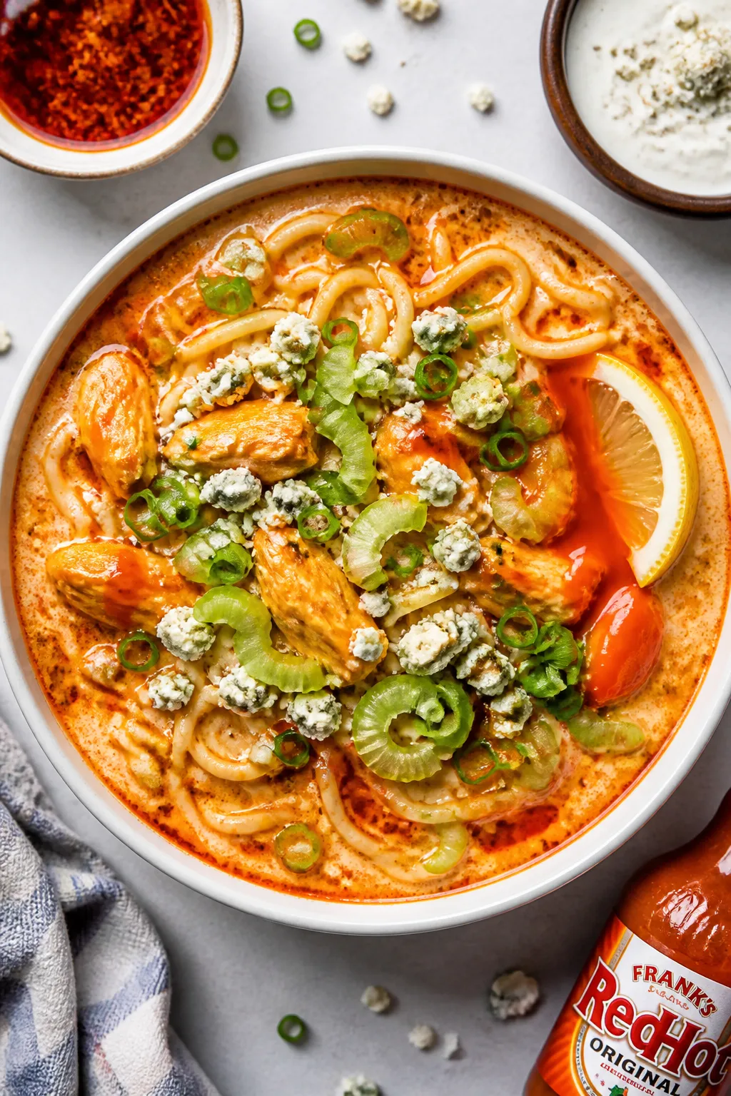 Tasty top view: Overhead shot of Buffalo Chicken Ramen for the table, visually layered; noodles coil