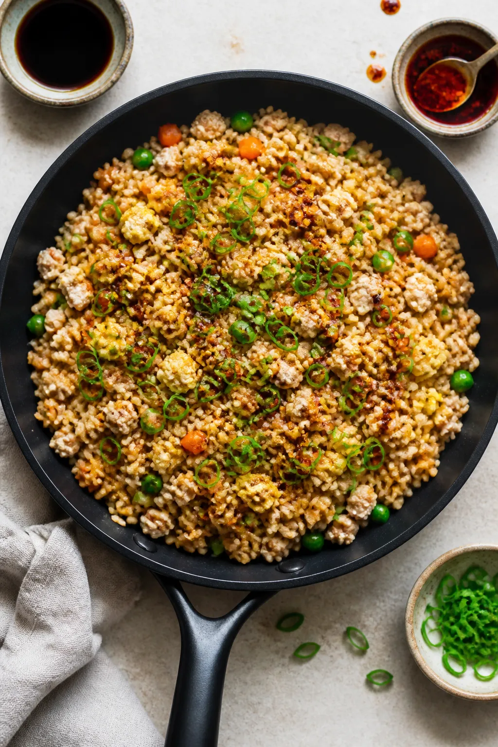 Tasty top view: Overhead shot of finished Ground Chicken Fried Rice in a wide black skillet, showing